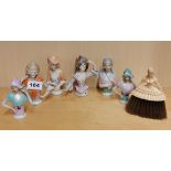 A group of six porcelain half dolls and a celluloid half doll brush, tallest 11cm.