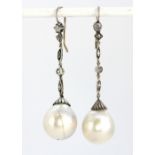 A pair of yellow and white metal (tested silver on gold) large pearl drop earring set with rose