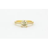 An 18ct yellow gold ring set with a cushion cut fancy light yellow diamond and brilliant cut diamond