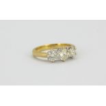 An 18ct yellow and white gold ring set with three brilliant cut diamonds, 1ct overall, (J.5).