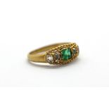 A yellow metal (tested 18ct gold) ring set with emerald and diamonds, (D.5).