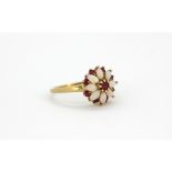 A 9ct yellow gold opal and ruby set cluster ring, (N.5).