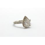An 18ct white gold (stamped 750) ring set with a pear cut diamond surrounded by brilliant cut