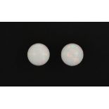 A pair of 9ct yellow gold opal set stud earrings, Dia. 0.8cm.