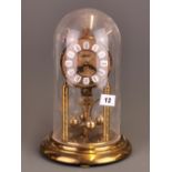 A Haller torsion clock under dome, H. 29cm.