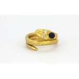 A yellow metal (tested 18ct yellow gold) sapphire and diamond set snake shaped ring, (O).