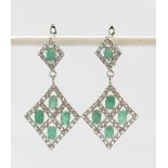 A pair of 925 silver drop earrings set with oval cut emeralds and white stones, L. 4cm.