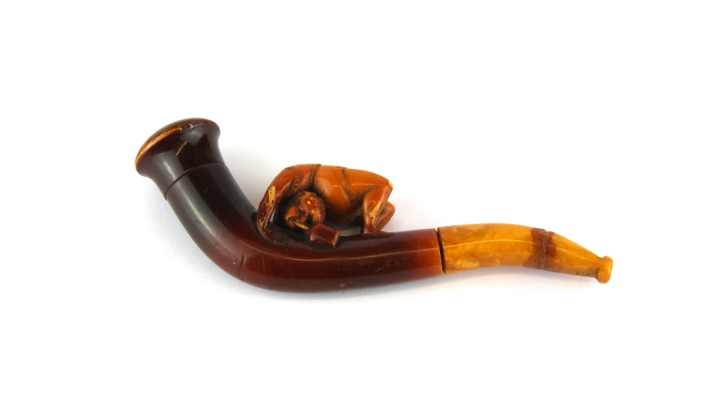 An unusual 19th Century meerschaum cheroot holder of a female acrobat, a/f to mouth piece, L. 12cm.