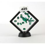 A quantity of un-mounted polished green gemstones.