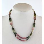 An unusual necklace of polished tourmaline beads, L. 48cm.