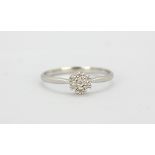 A 9ct white gold diamond set daisy cluster ring, (N.5).