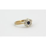 An 18ct yellow gold sapphire and diamond set cluster ring, (I.5).