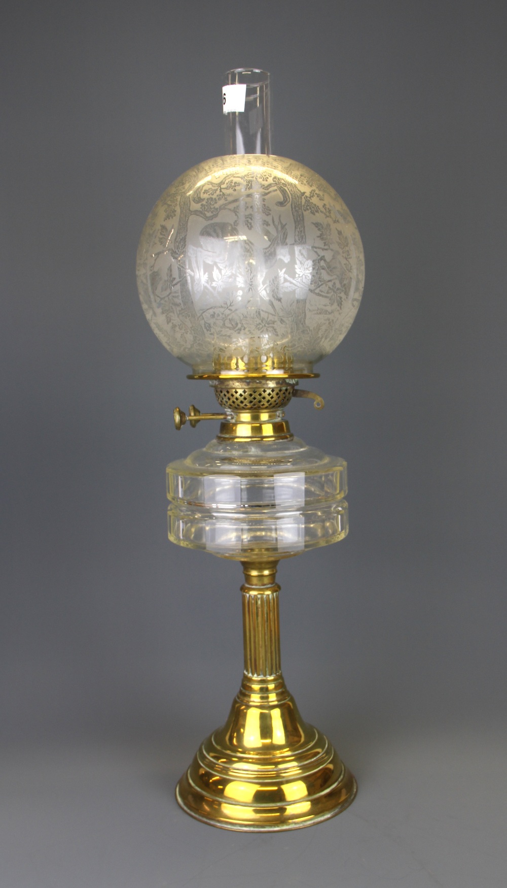 An Edwardian brass and glass oil lamp with frosted shade, H. 62cm.