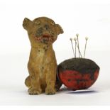 An early 20th Century cold painted metal bonzo dog pin cushion, H. 7.5cm.