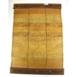 A Mongolian folding wood and bamboo folding book of engraved pages featuring a Buddhist deity and