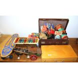 A vintage case with a child's wood working set and other toys and games.