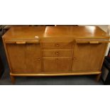 A 1950's satin walnut sideboard/ cocktail cabinet with two glass topped pull out shelves, W.