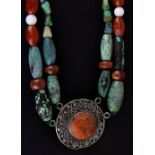 A Tibetan white metal turquoise, agate and gold stone Tribal necklace, folded L. 39cm.