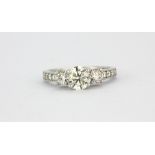 An 18ct white gold (stamped 750) trilogy ring set with three brilliant cut diamonds and diamond