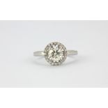 An 18ct white gold (stamped 750) halo ring set with a 1.01ct brilliant cut centre diamond surrounded