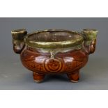 An interesting Chinese glazed pottery oil lamp, W. 15cm, H. 9cm.