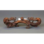 A Chinese carved wooden dragon brush rest, W. 17cm.