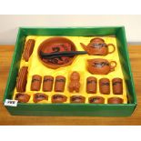 A boxed Japanese terracotta tea set.