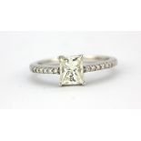 An 18ct white gold (stamped 18k) ring set with a 1ct princess cut diamond and brilliant cut