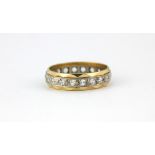 An 18ct yellow and white gold full eternity ring set with white quartz, (K.5).