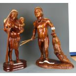Two large South American carved wooden Tribal figures of a man returning from the hunt and a women