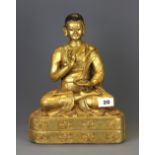 A large Tibetan gilt bronze figure of a deity, H. 30cm.