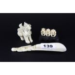 A 19th Century Chinese carved ivory shoe horn, L. 14.5cm, together with a Chinese ivory dragon and