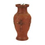 An Oriental carved terracotta vase, H. 31cm.