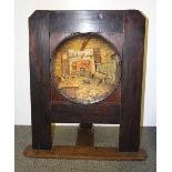 An interesting 1920's pine fire screen inset with a plaster plaque, W. 55cm, H. 73cm.