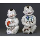 A pair of early to mid 20th Century Chinese porcelain figures of babies, H. 20cm.