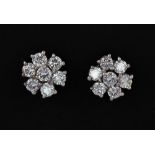 A pair of 18ct white gold (stamped 750) diamond set cluster earrings, approx. 1.10ct overall, Dia.