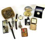 A box of mixed watches and other items.