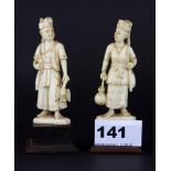 A pair of early 20th Century Indian carved ivory figures mounted on hardwood bases, H. 11cm.