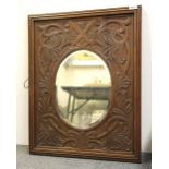 A carved oak framed mirror with Scottish thistle shield, 60 x 76cm.