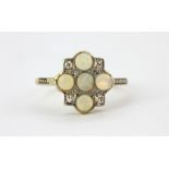 An early 20th century 18ct yellow gold and platinum ring set with cabochon cut opals and