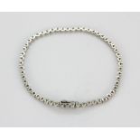 An 18ct white gold (stamped 750) tennis bracelet set with brilliant cut diamonds, approx. 1.30ct, L.