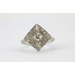 An 18ct white gold (stamped 750) diamond set cluster ring, approx. 0.75ct overall, (O.5).