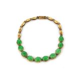 A yellow metal (tested 9ct gold) nephrite jade set bracelet.
