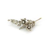 A white metal (tested silver) brooch set with old cut diamonds, approx. 1.45ct overall, L. 5cm.