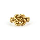 A 9ct yellow gold knot ring, (S.5).