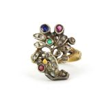 An early yellow and white metal (tested gold and silver) ring set with ruby, sapphire, emerald and