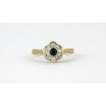 An 18ct yellow gold sapphire and diamond set cluster ring, (I.5).