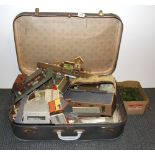 A vintage case containing a quantity of 00 gauge model railway accessories.