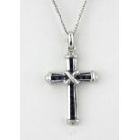 A 9ct white gold sapphire set cross pendant and chain, L. 2.5cm.