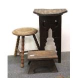 A carved 19th Century Eastern style table and two carved stools, table 36 x 36 x 55cm.